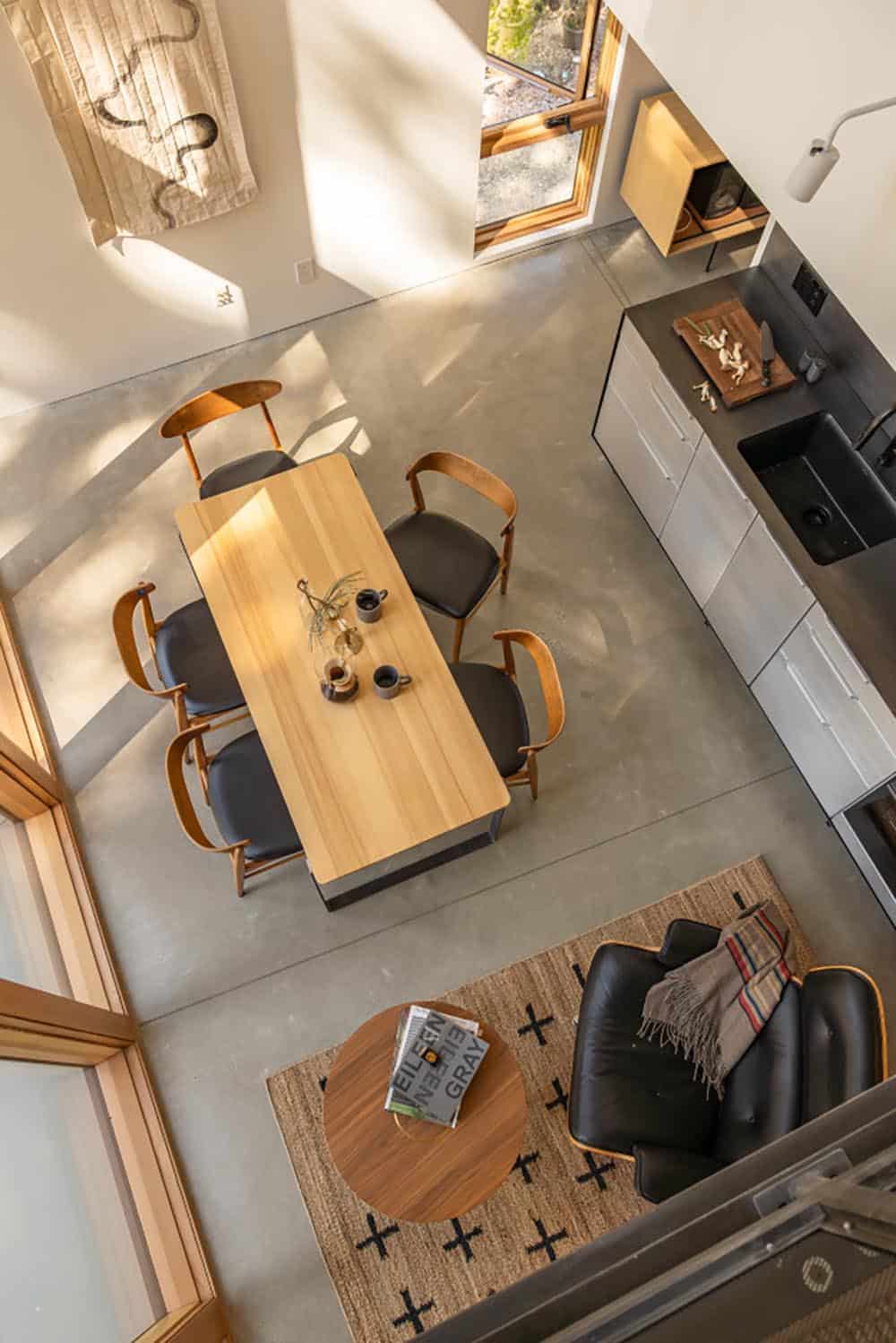 Overhead view of open-plan kitchen dining and living area with concrete floors
