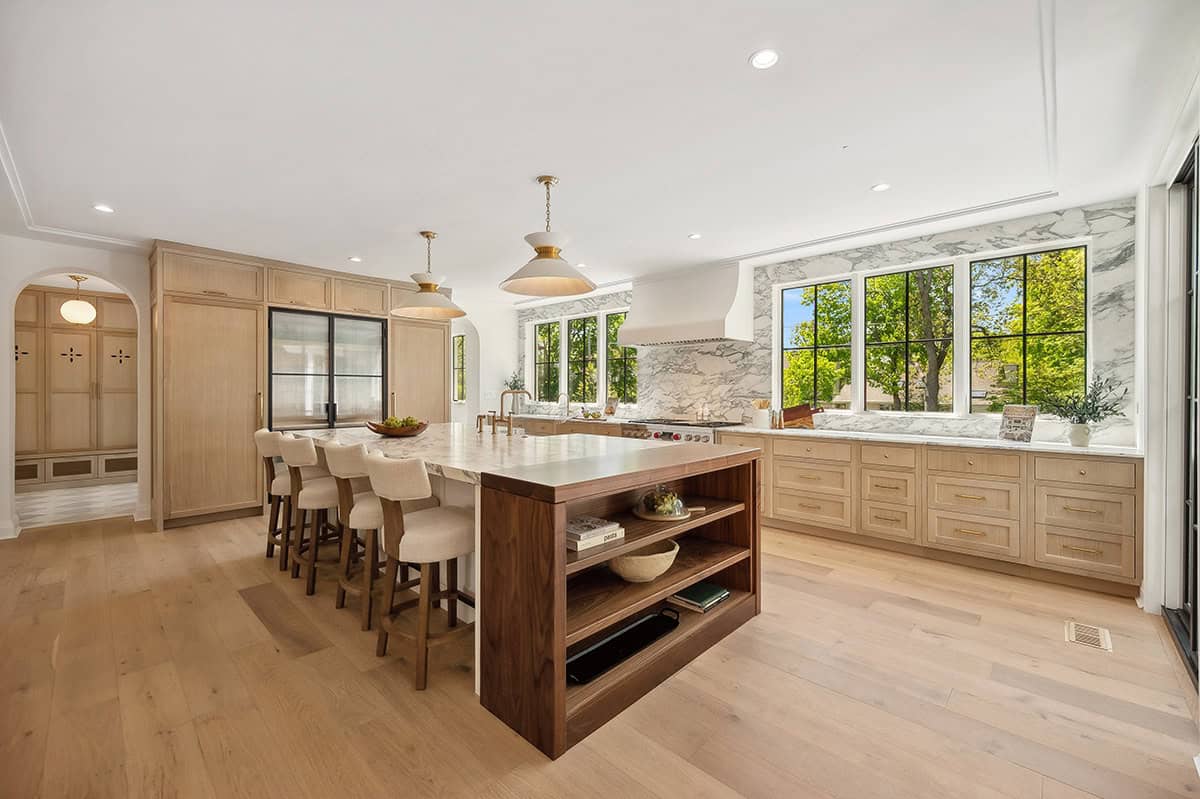 Bright kitchen with walnut island and floor to ceiling windows