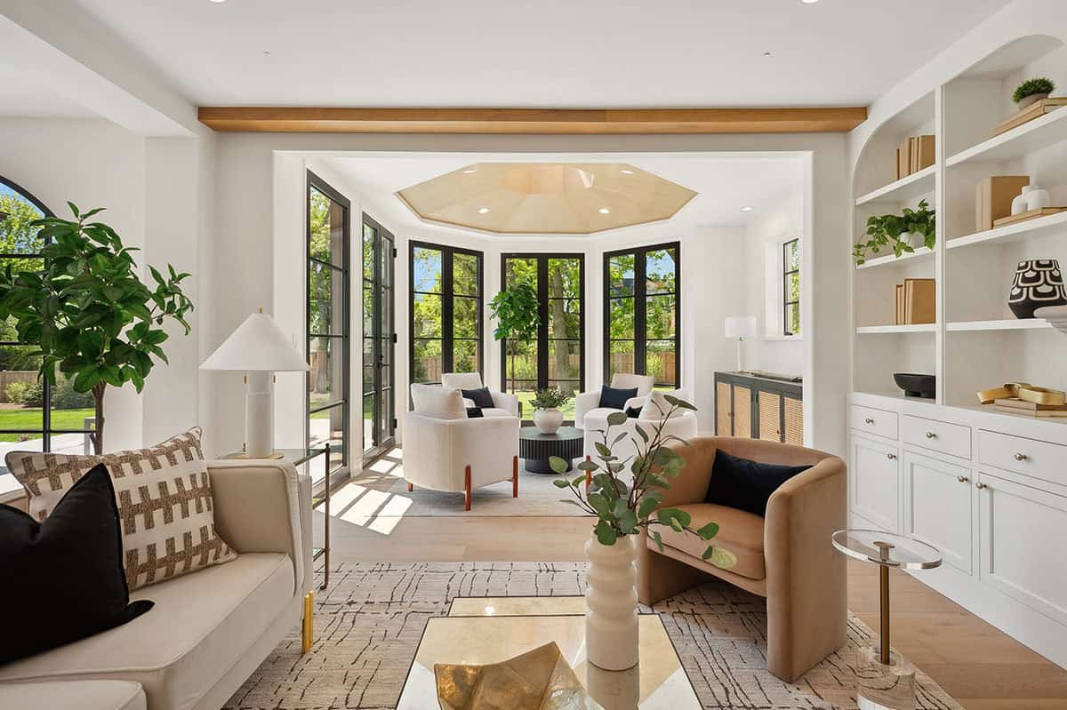 Sunroom seating area with black steel doors and windows