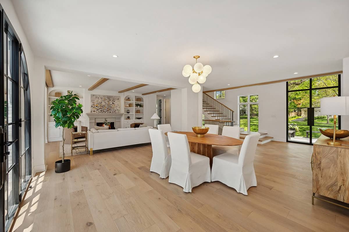 Open dining and living area with wood beamed ceiling