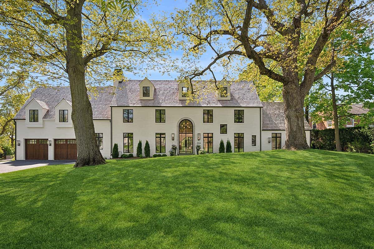 Exterior front view of white brick English country home