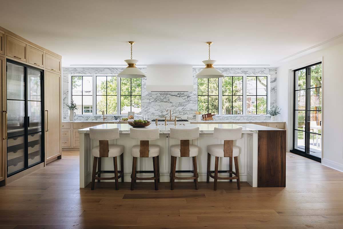 Wide view of kitchen island with wood accent and seating