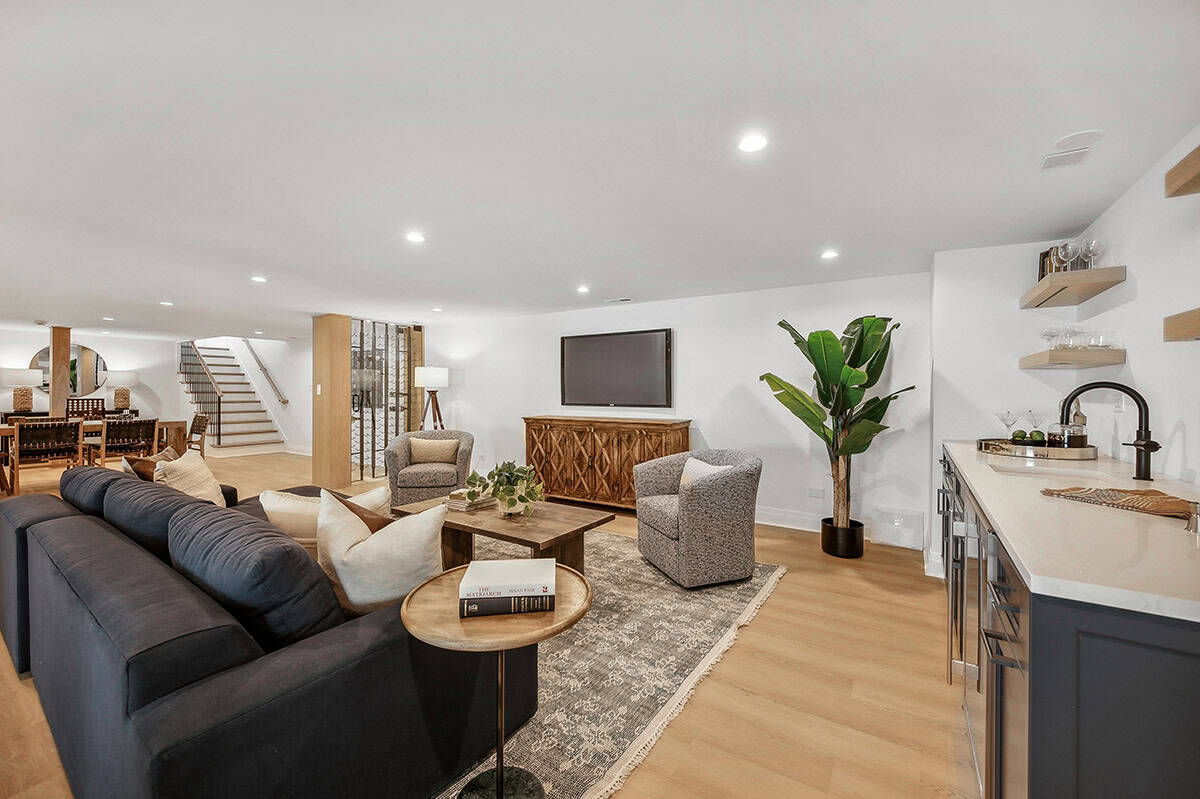 Basement lounge with navy sofa and wet bar area