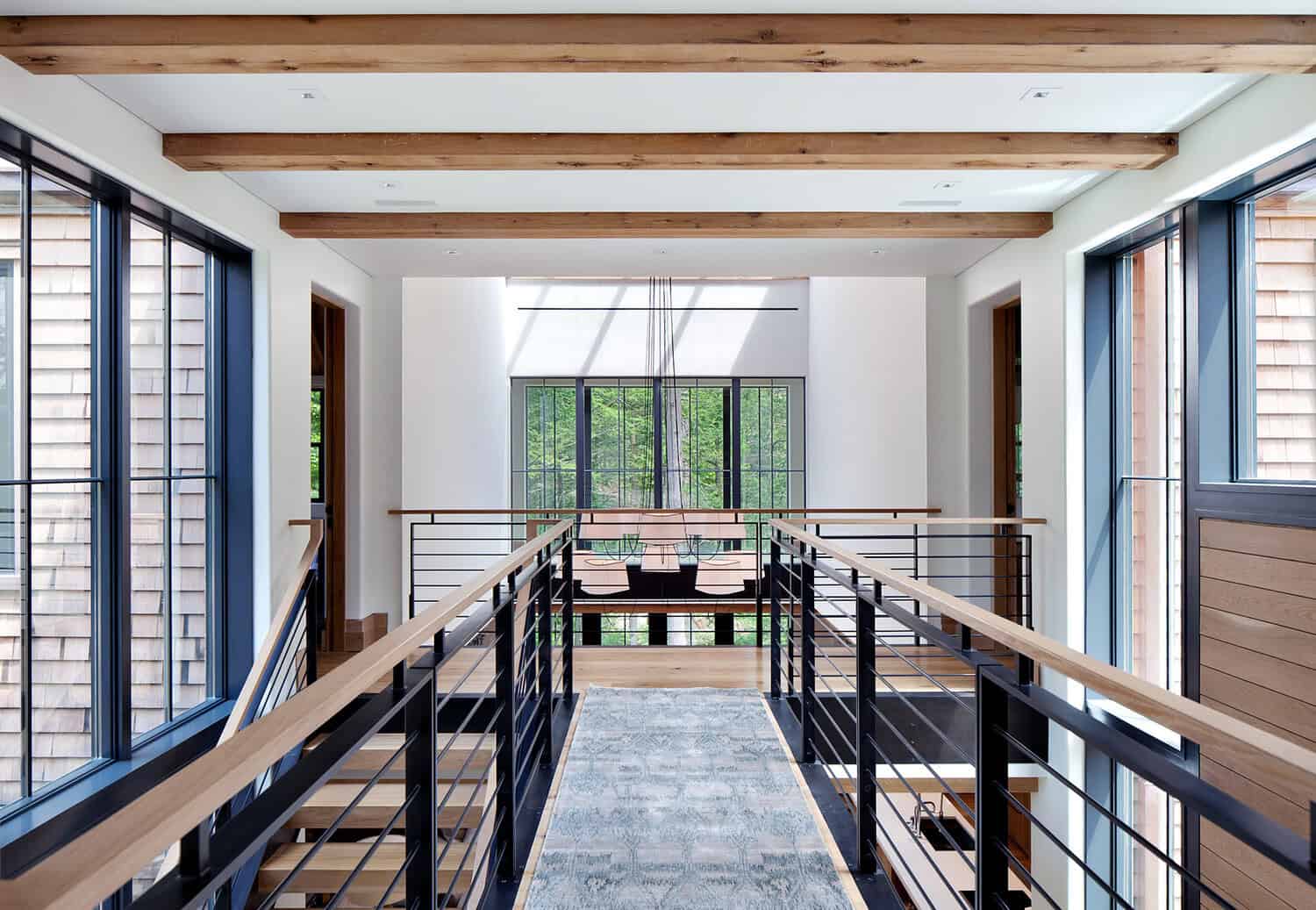 Upper-level walkway with cable railing overlooking dining area
