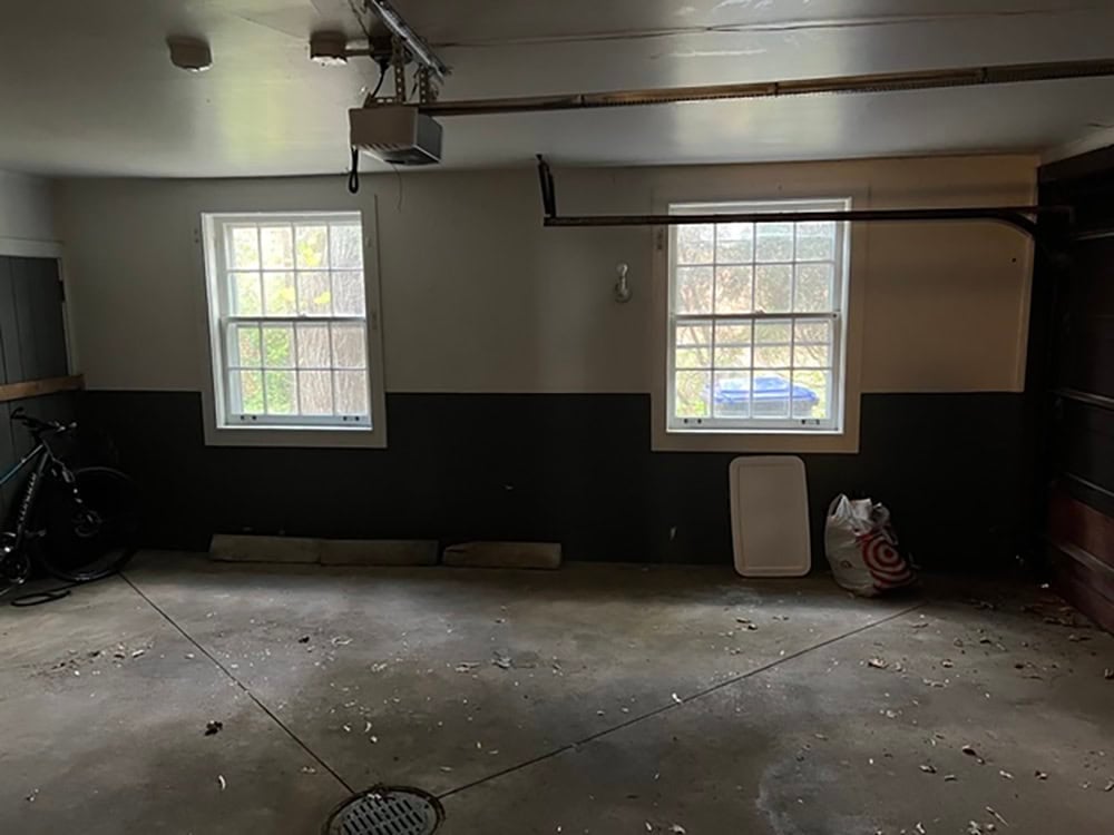 Garage interior with dark wainscoting before renovation and remodel