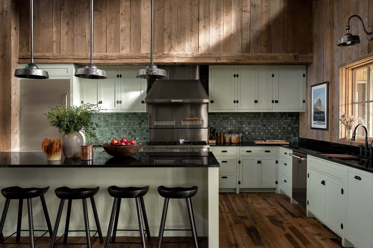 Rustic kitchen with sage-green cabinets and green tile backsplash