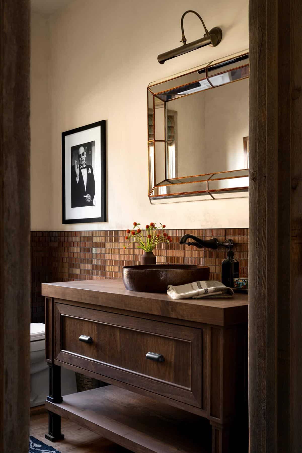 Powder room with hammered copper vessel sink and tiled backsplash