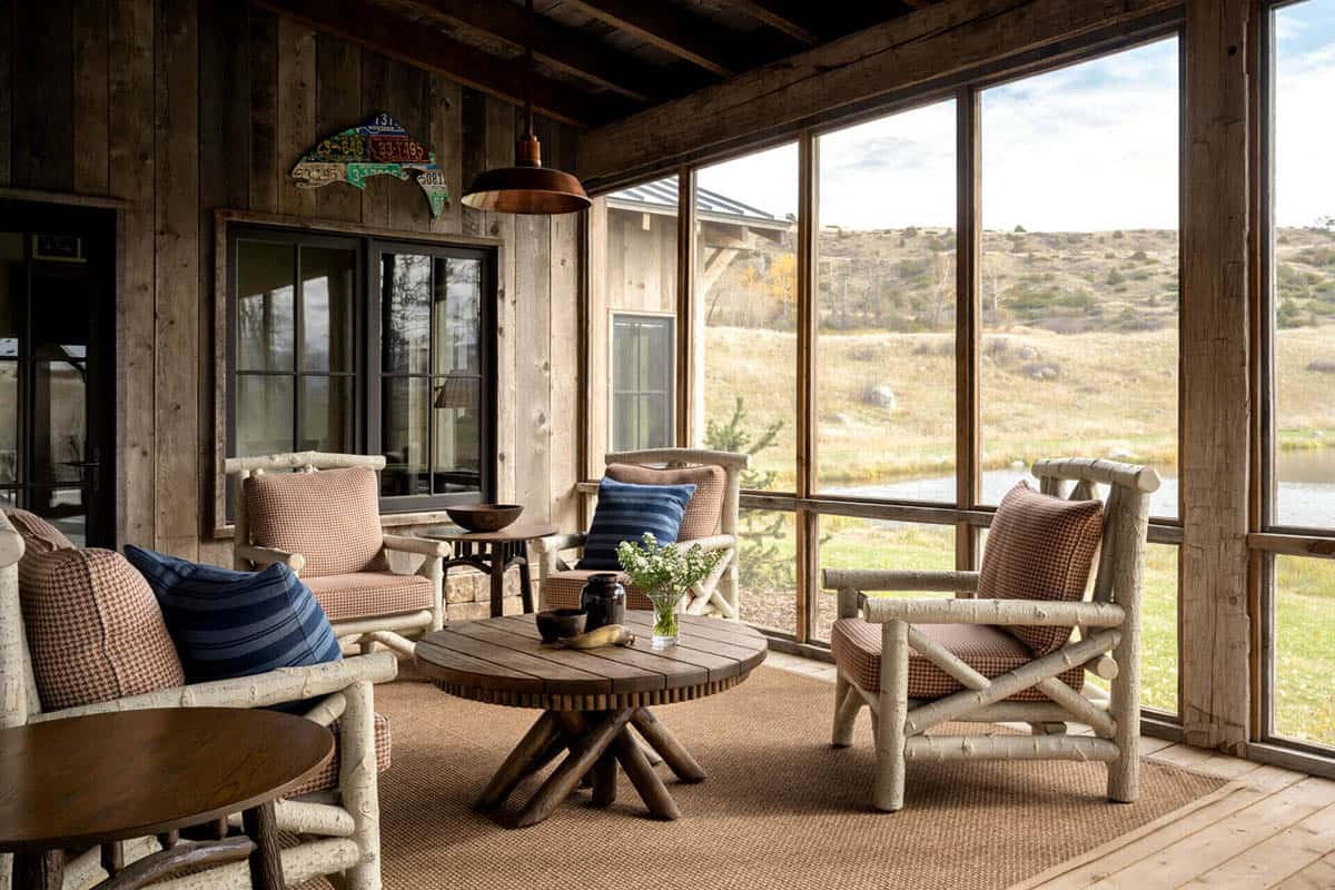 Screened porch with woven chairs overlooking the pond
