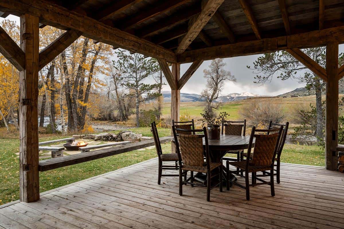 Covered outdoor dining area with fire pit and mountain view