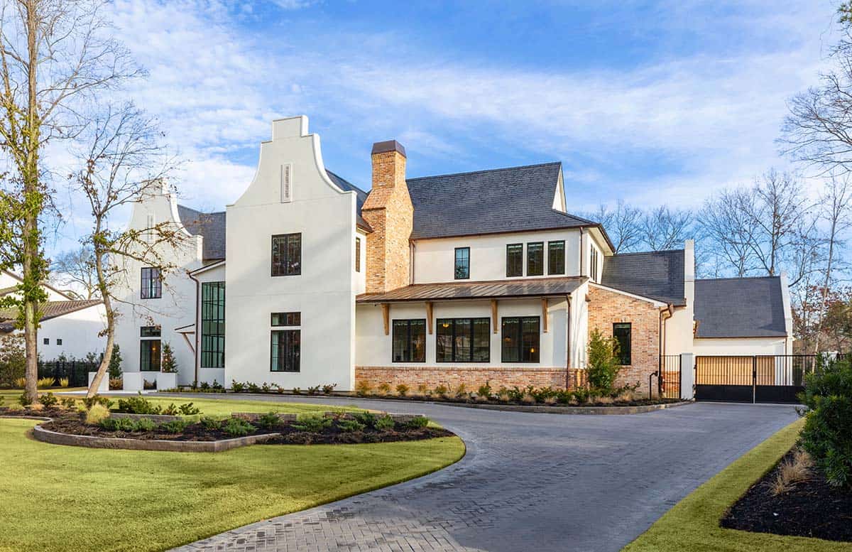 Cape Dutch home exterior showing curved gable, brick chimney, and circular driveway
