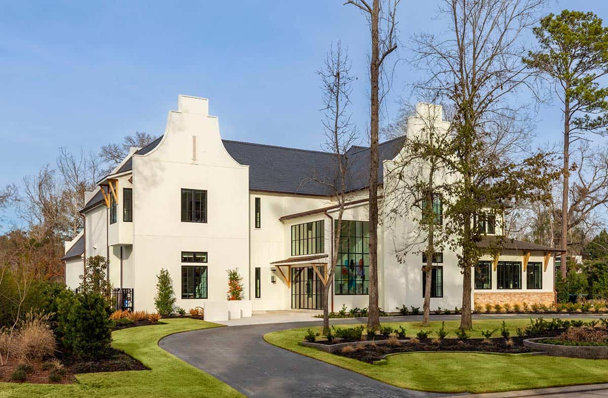 White stucco Cape Dutch home with curved parapet gable and glass entry doors