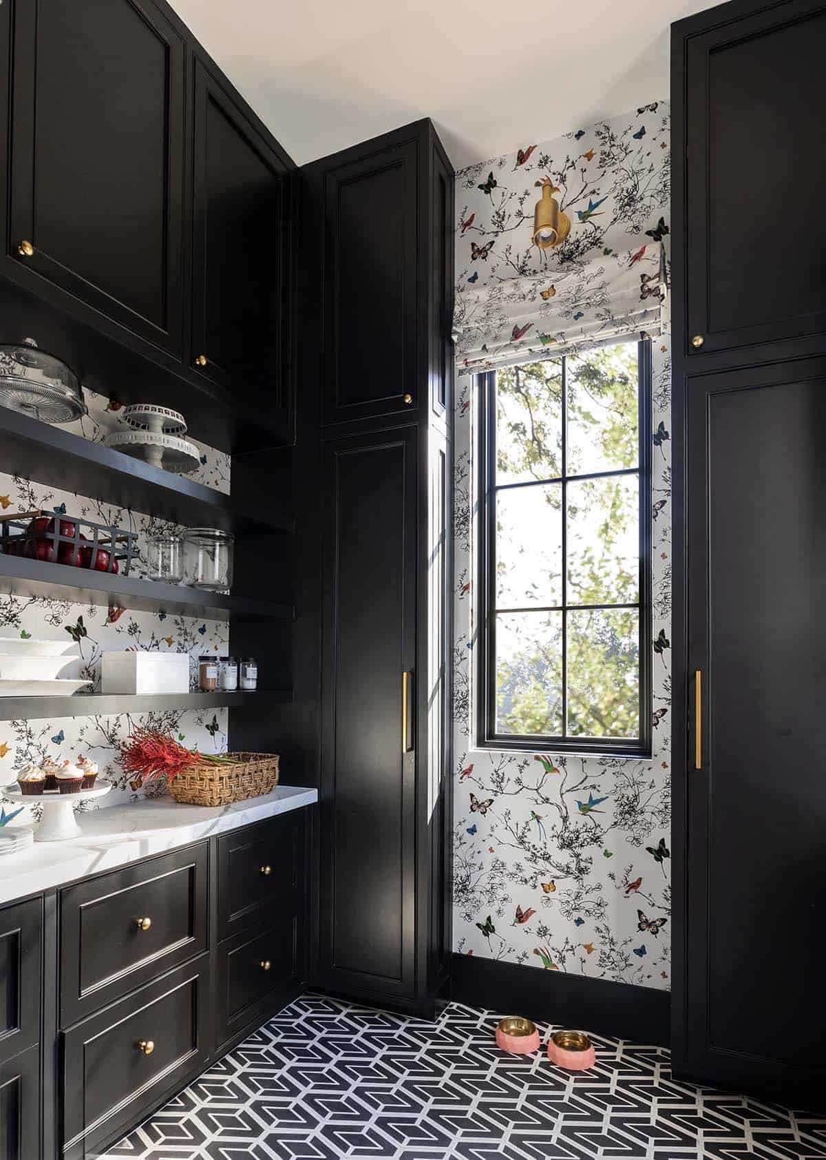 Black butler's pantry with bird and butterfly wallpaper and geometric floor tile