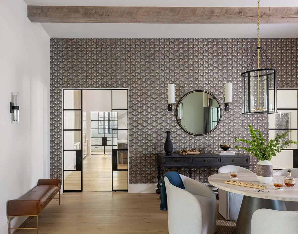 Dining nook with geometric wallpaper, round mirror, and black console table