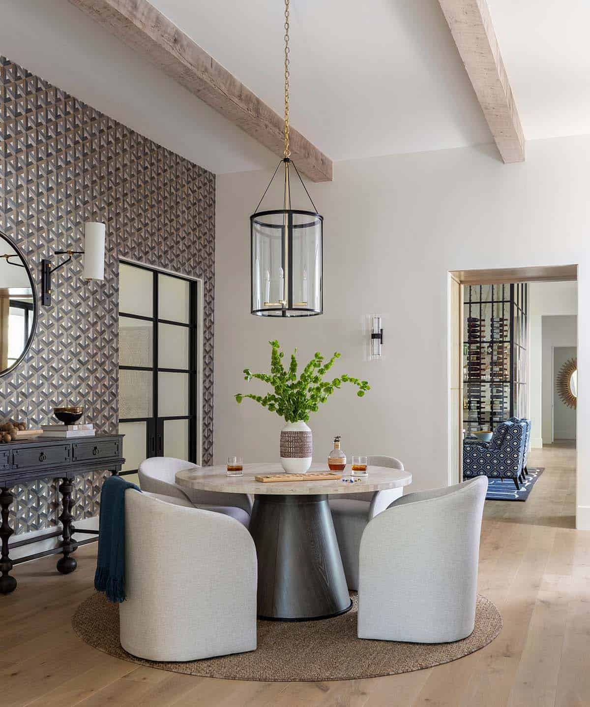 Round game table with lantern pendant and geometric accent wall