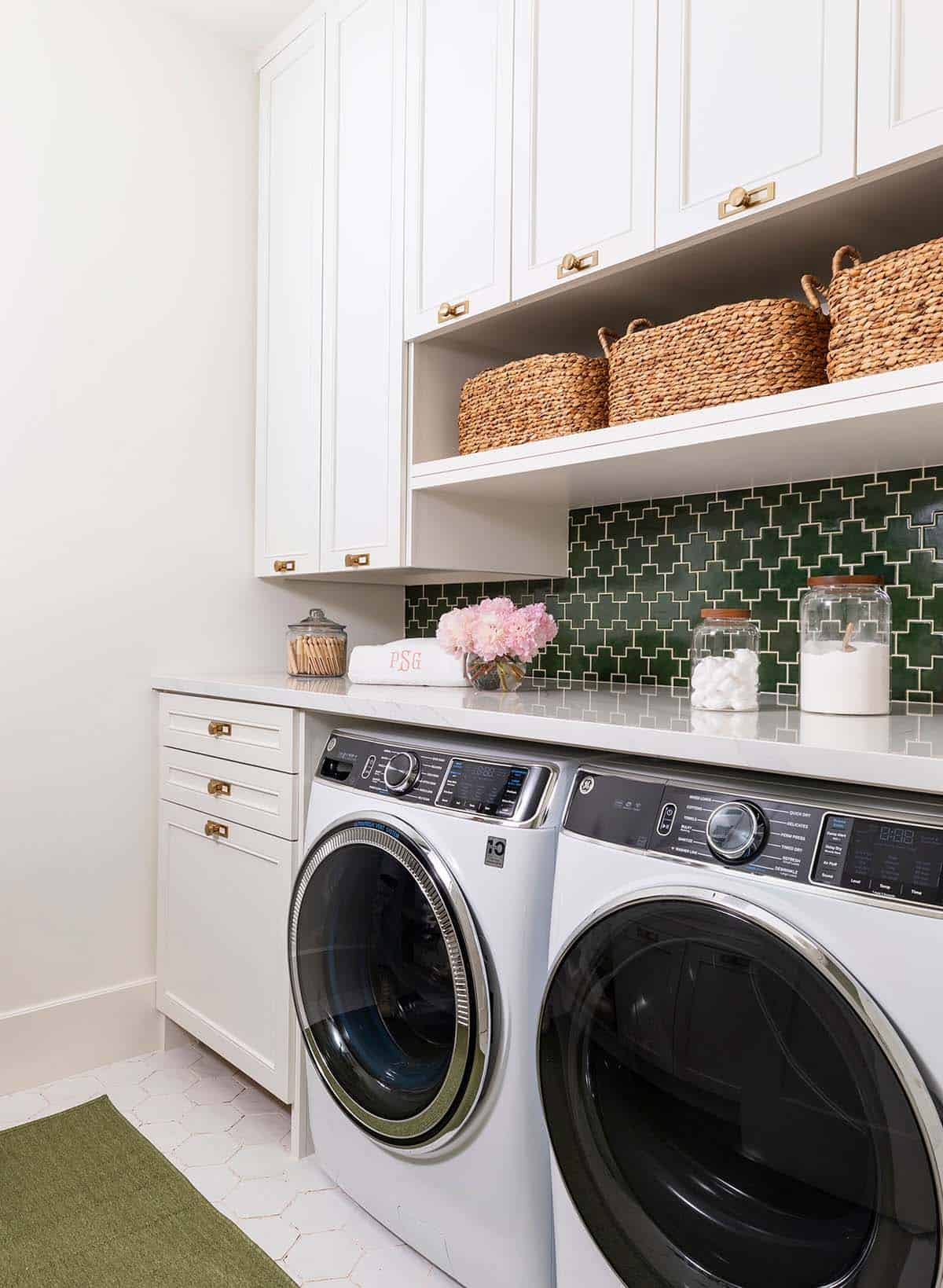 Laundry room with green cross-pattern tile backsplash and woven baskets