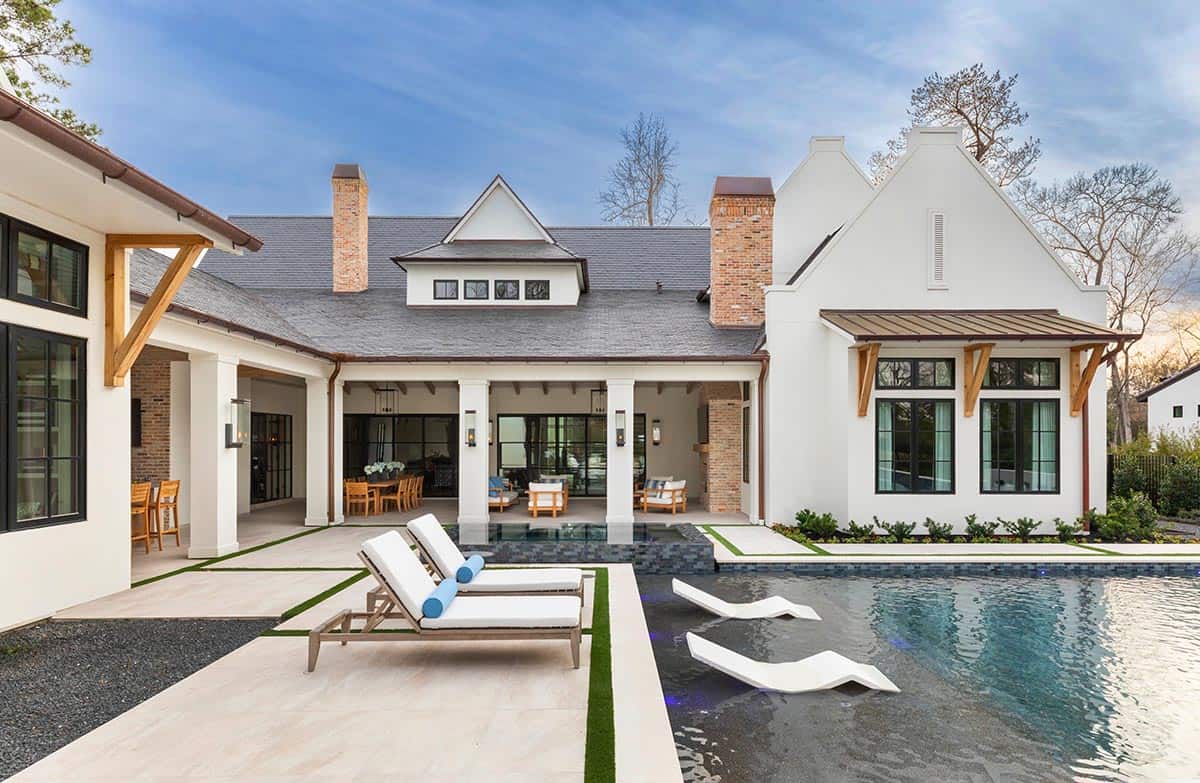 Rear exterior with pool, in-water loungers, and covered patio