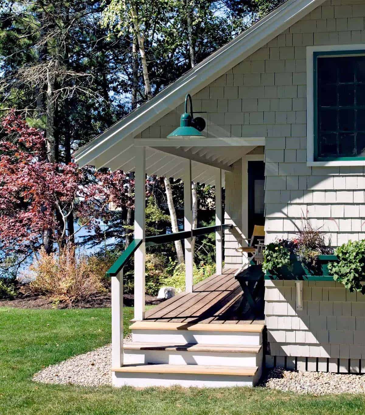 Guest cottage porch with green gooseneck light and flower box