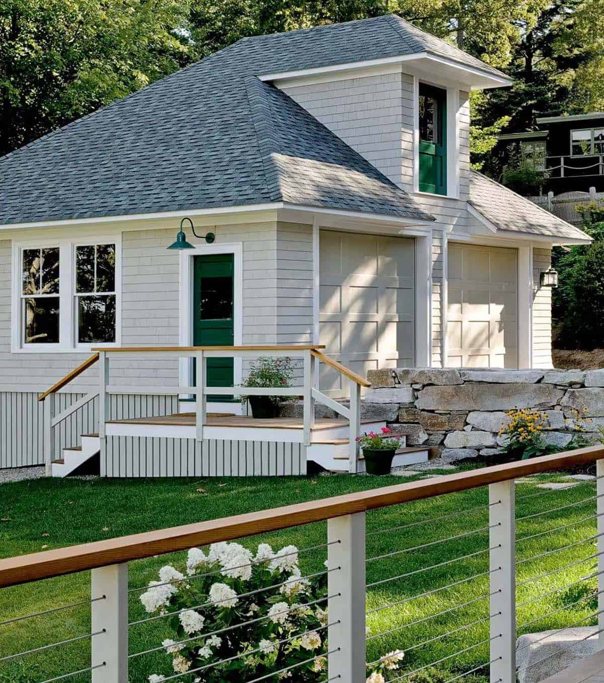 Garage and carriage house with green door and dormer window