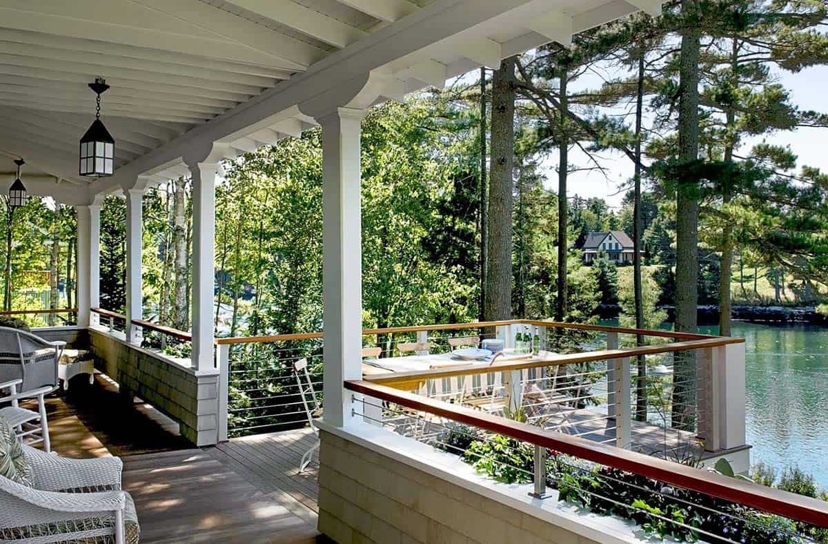 Covered porch dining area overlooking the harbor and pines