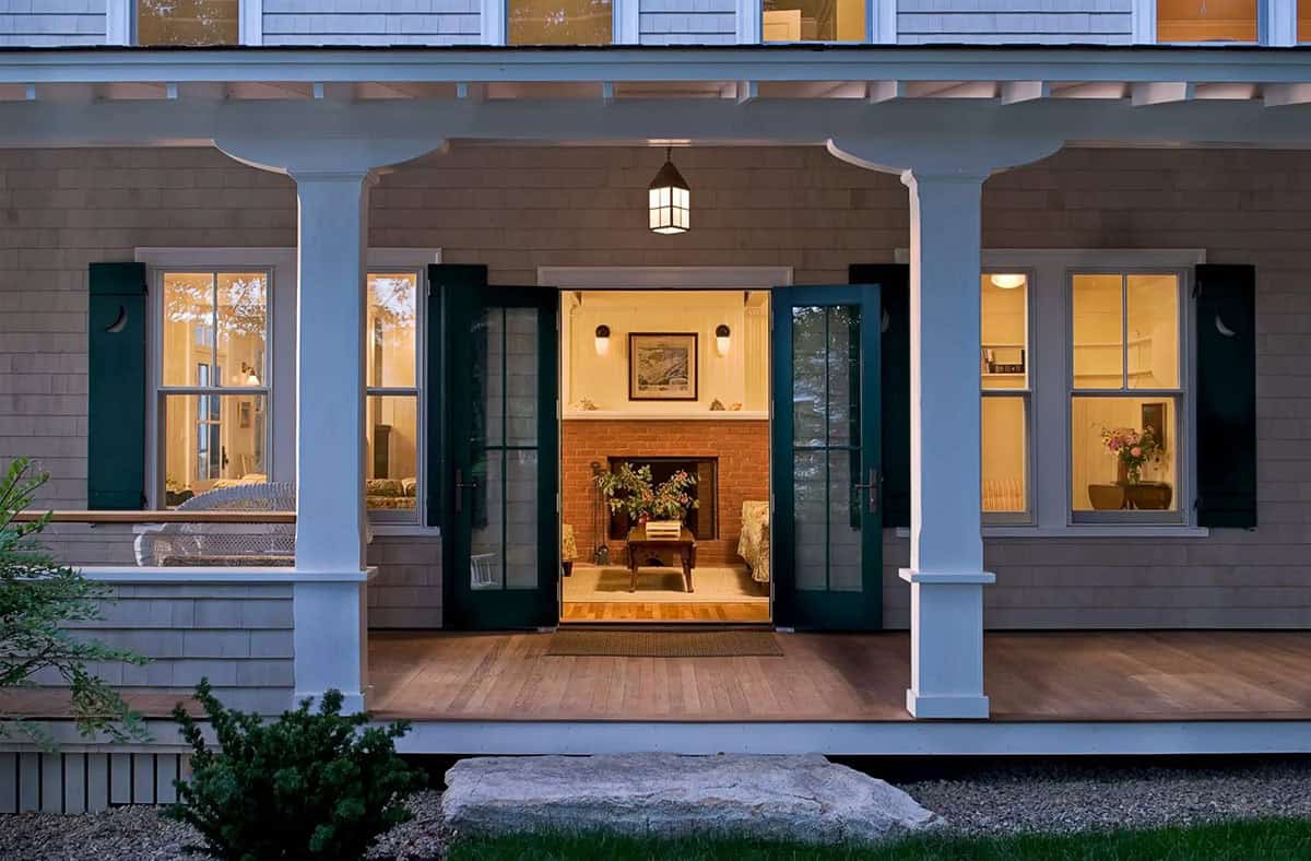 Front porch entrance with fireplace visible through open doors
