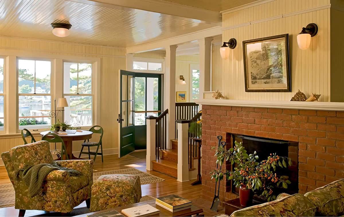 Living room with brick fireplace and harbor view through windows