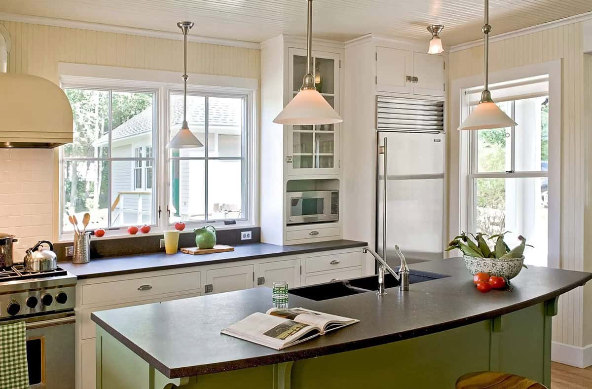 White kitchen with green island and stainless steel refrigerator