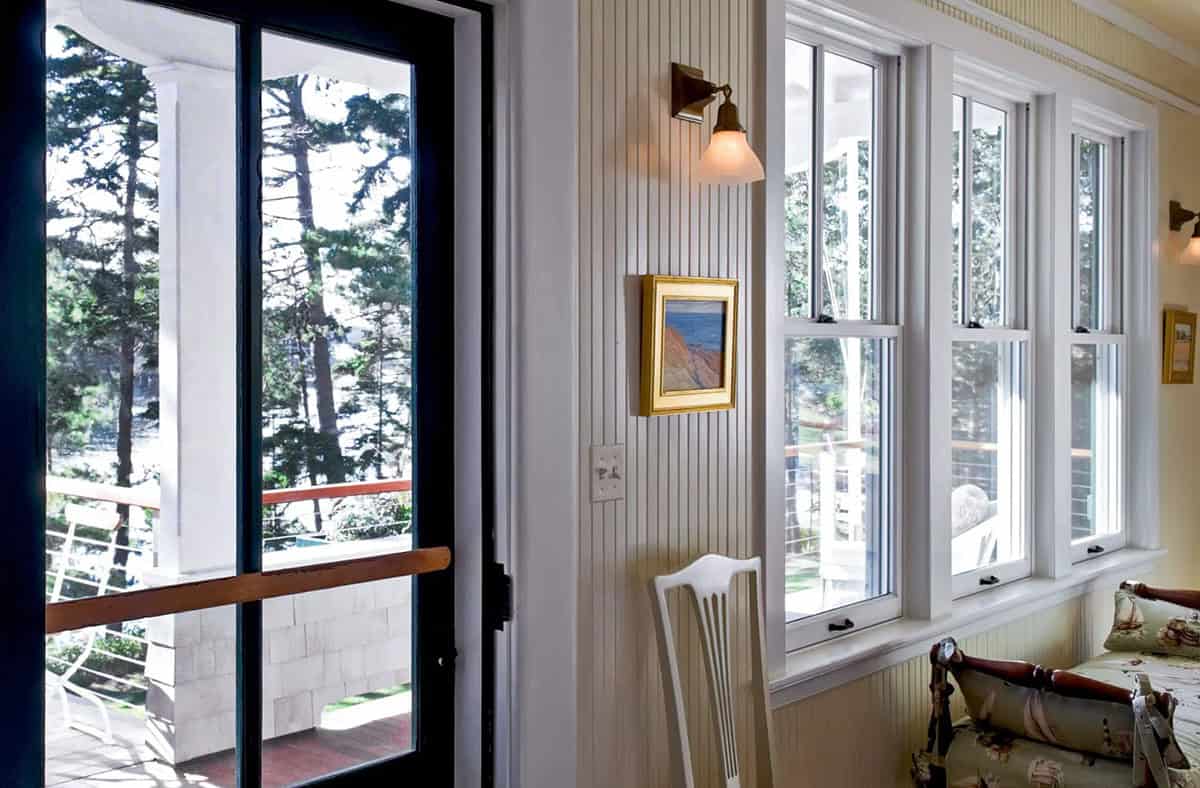 Sunroom windows framing harbor and treeline views