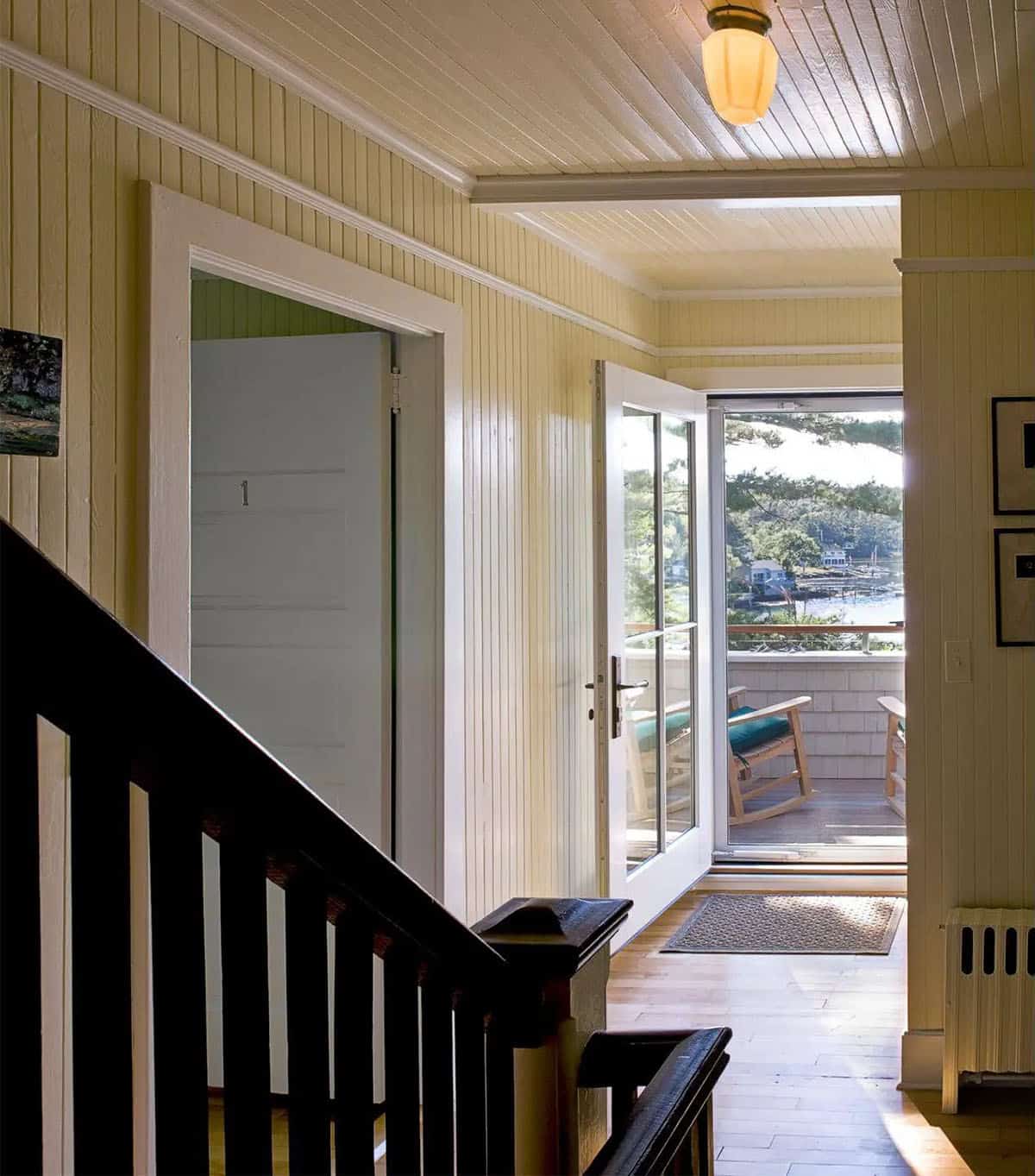 Upstairs hallway leading to a private harbor-view balcony