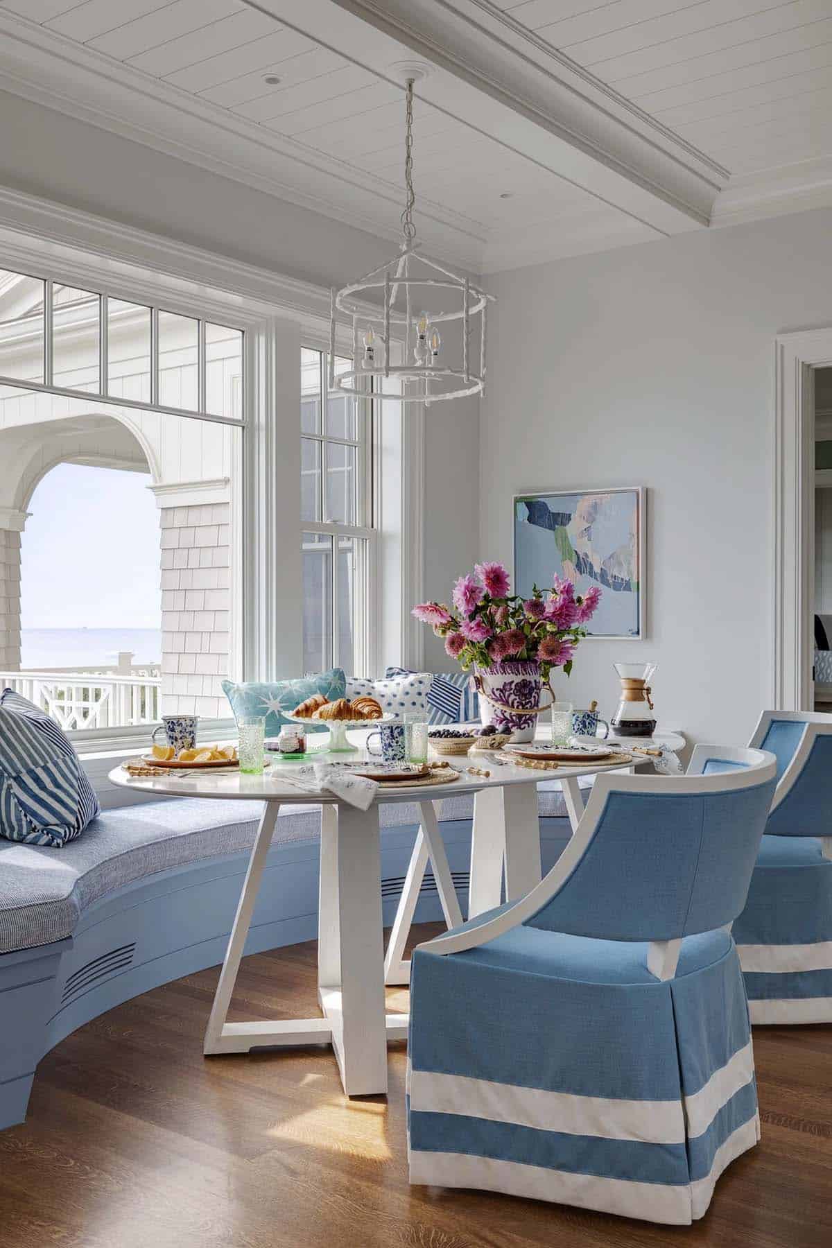 Blue and white breakfast nook with curved banquette and ocean view