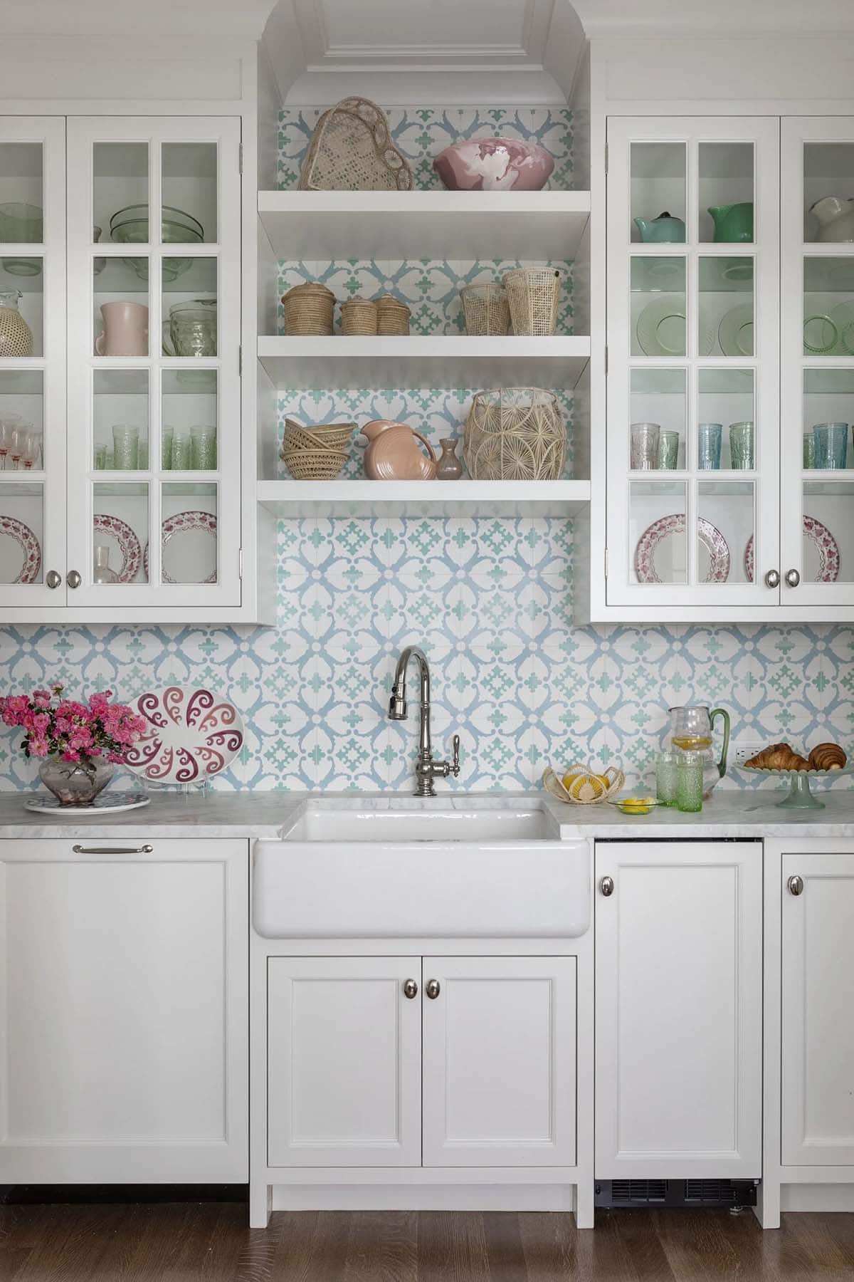 Butler's pantry with scalloped blue tile backsplash and glass cabinets