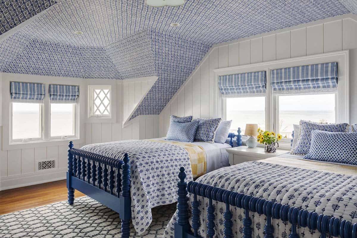 Twin bedroom with navy spindle beds and block-print ceiling