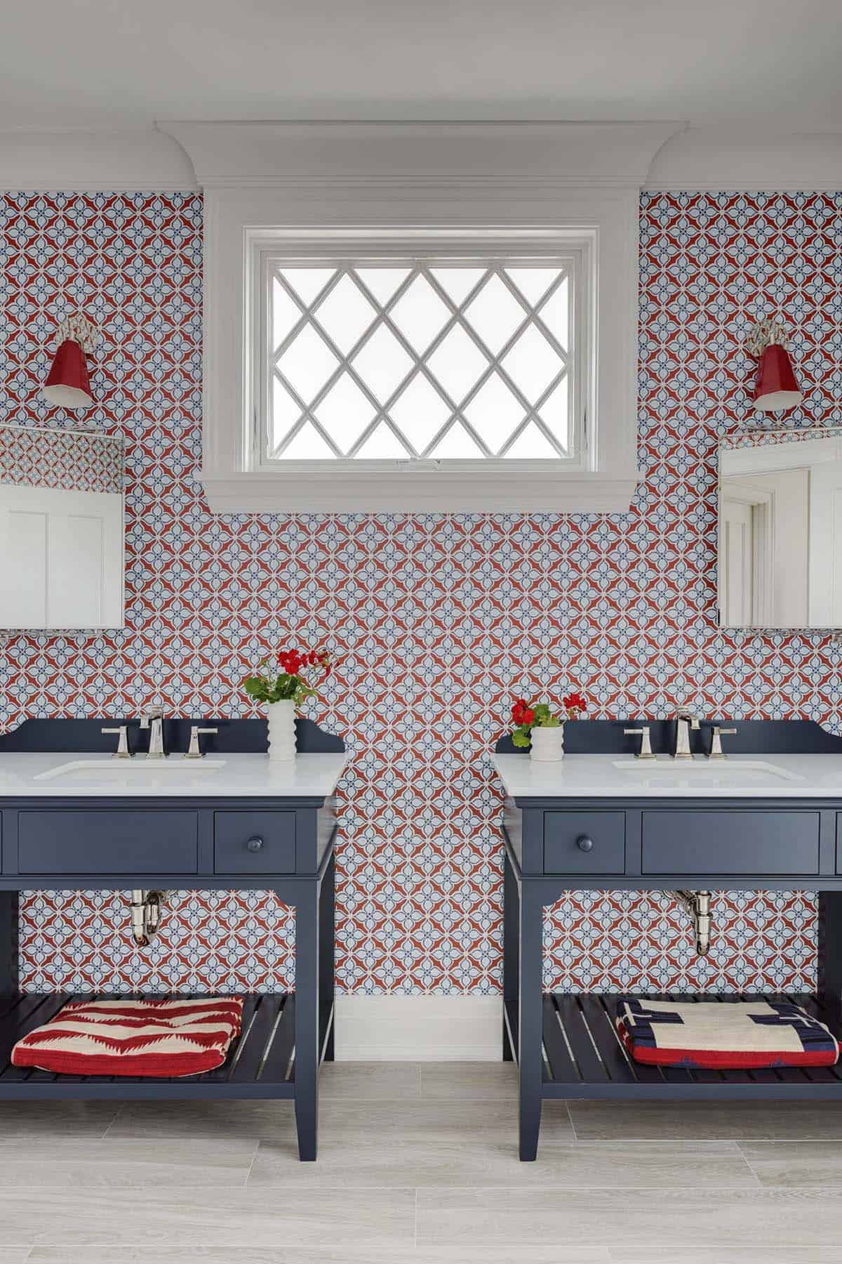 Red white and blue tiled bathroom with matching vanities