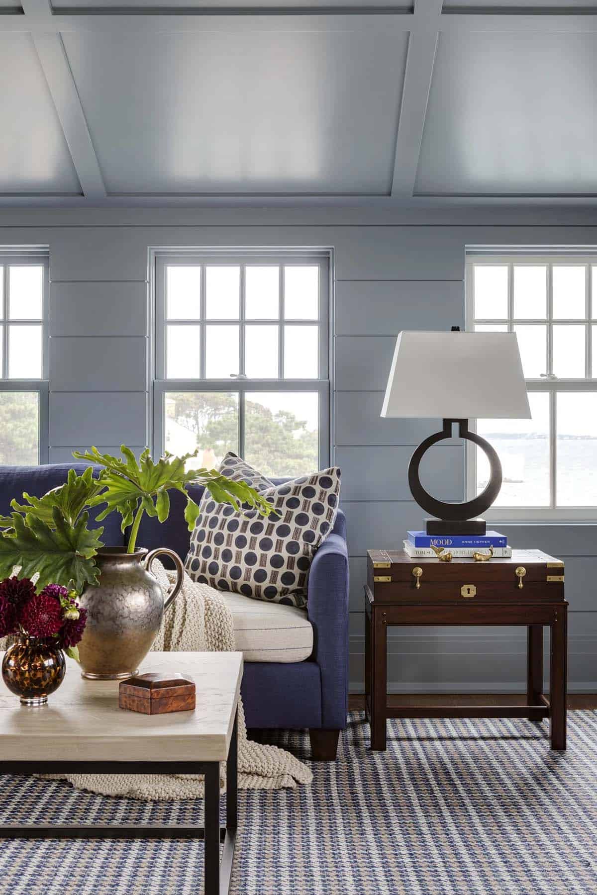 Navy sofa detail with knit throw and patterned pillow