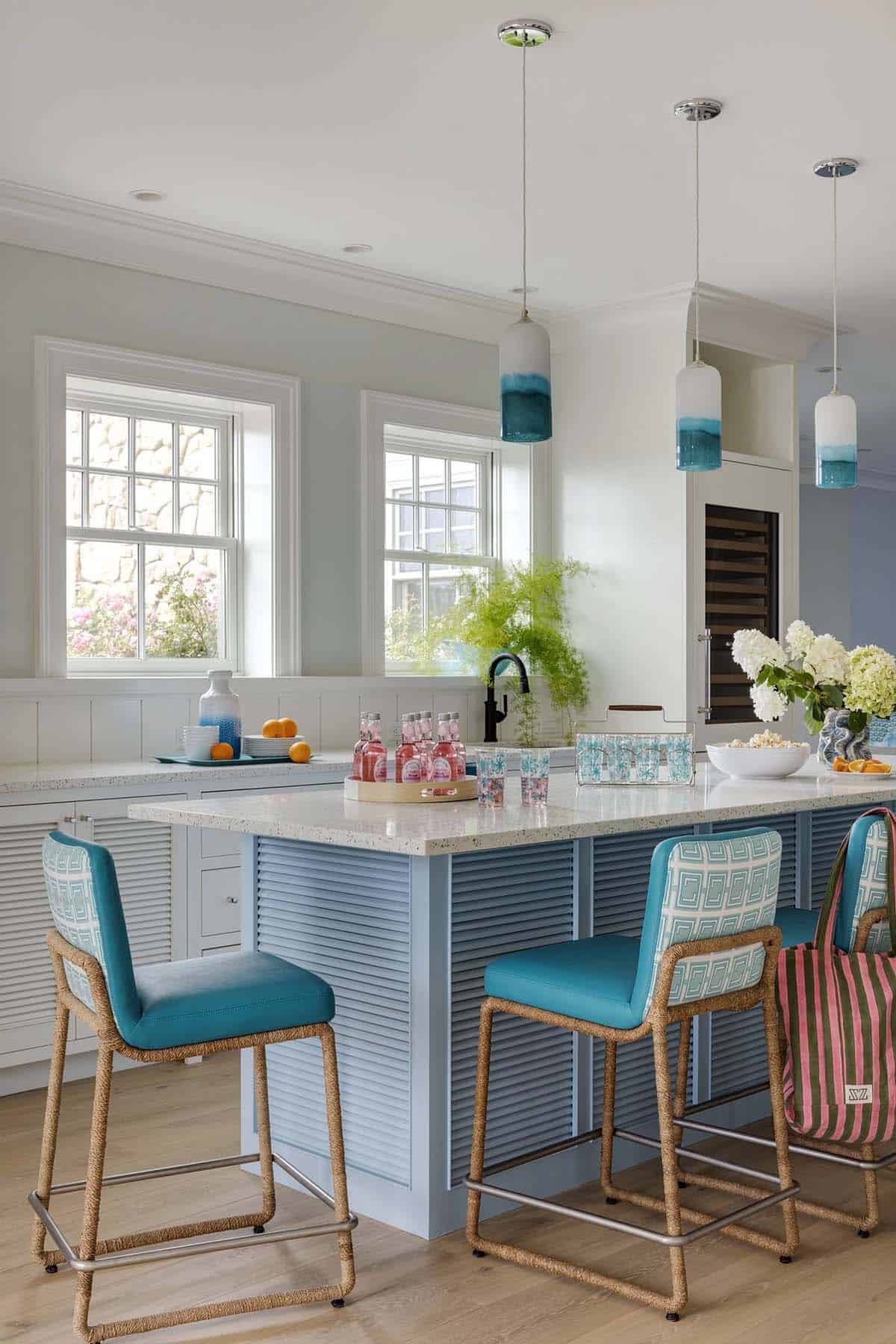 Kitchen island with teal barstools and dip-dyed glass pendants