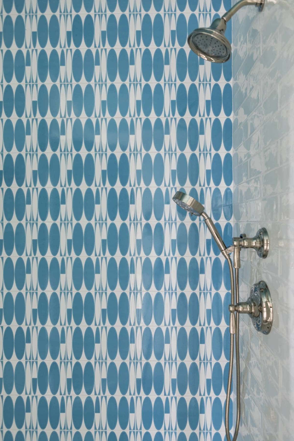 Detail of blue oval mosaic tile in shower stall