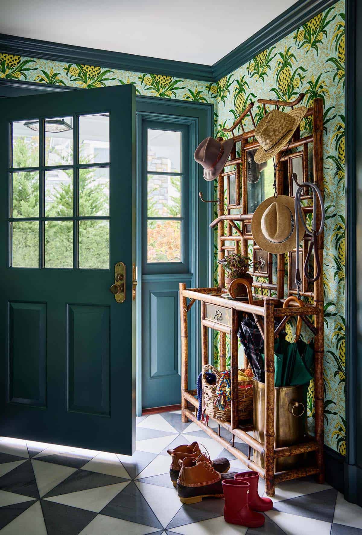 Entryway mudroom with pineapple wallpaper and bamboo hall tree