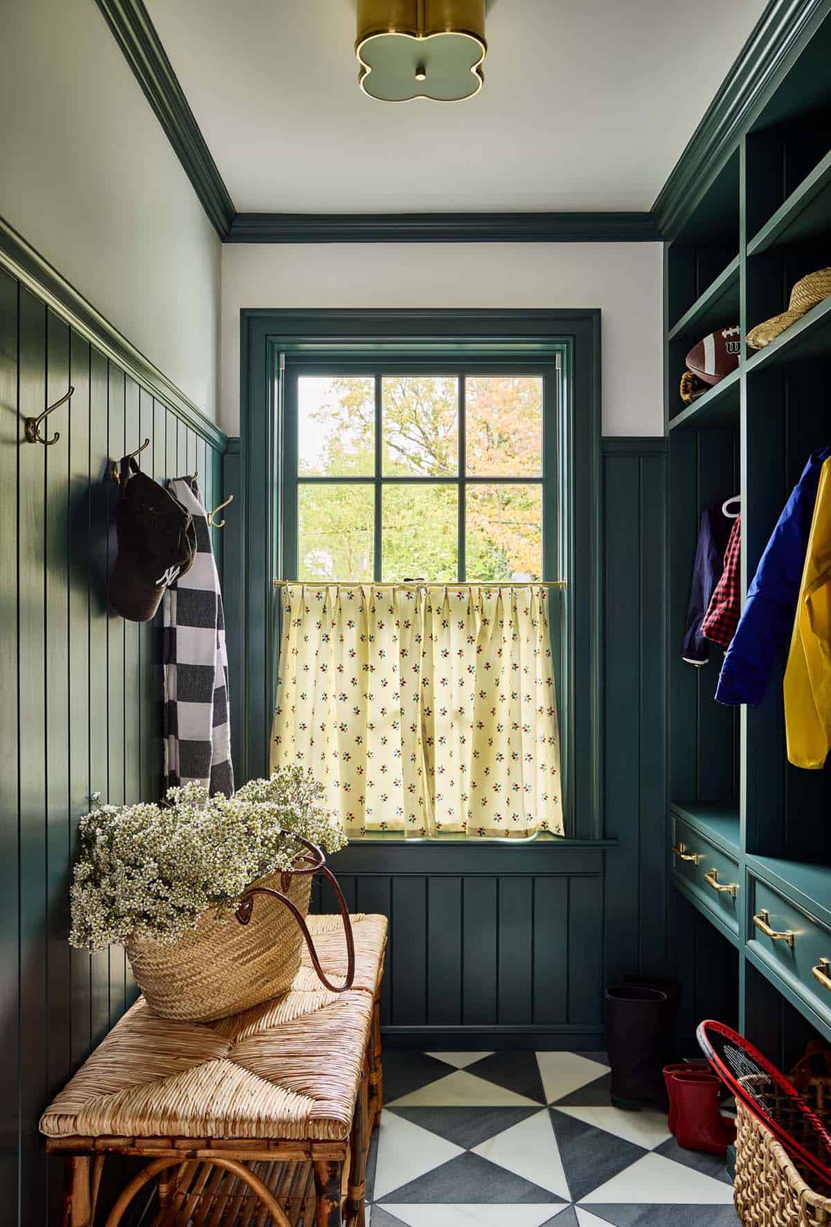 Mudroom with dark green paneling and yellow floral curtains