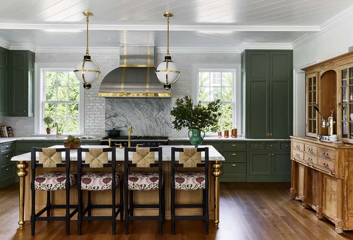 Kitchen with dark green cabinetry and brass hardware