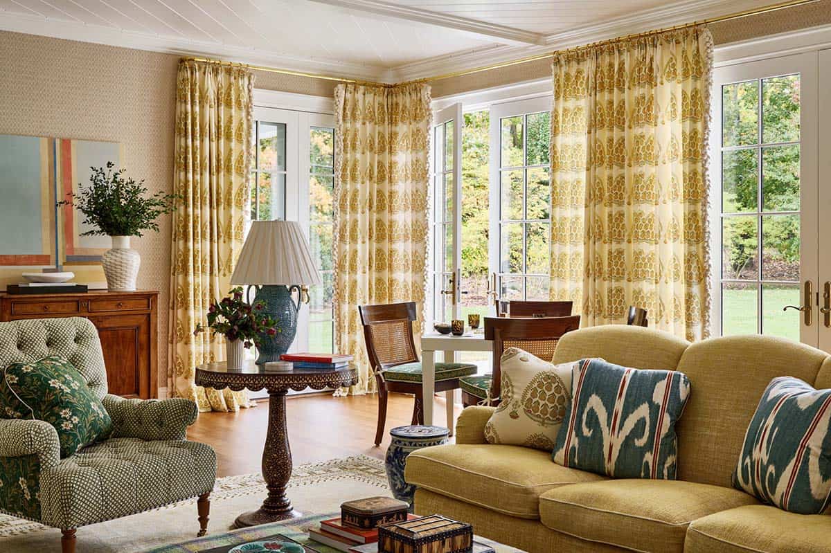Sitting room with mustard curtains and French doors to garden