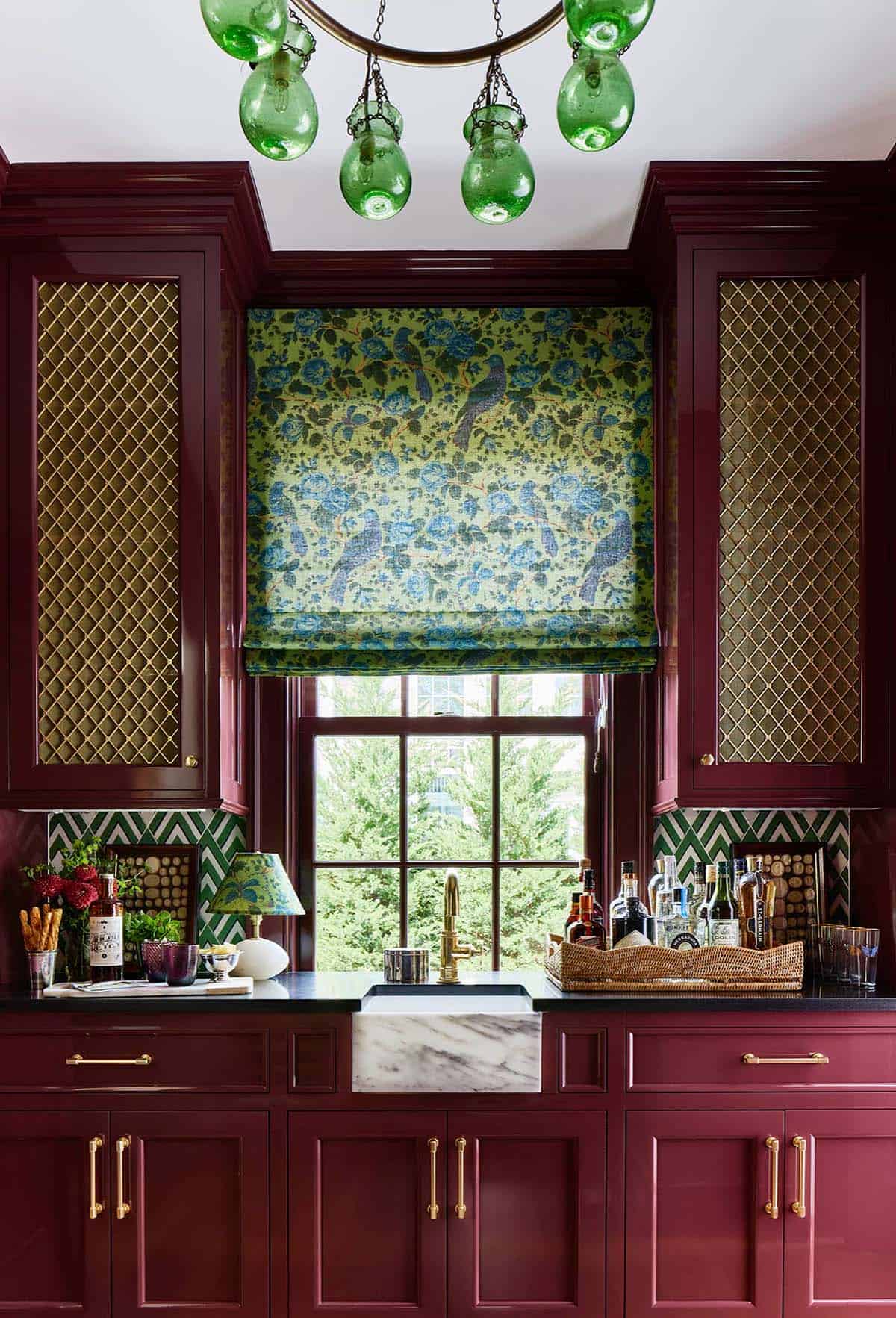 Butler's pantry with burgundy cabinetry and green glass chandelier