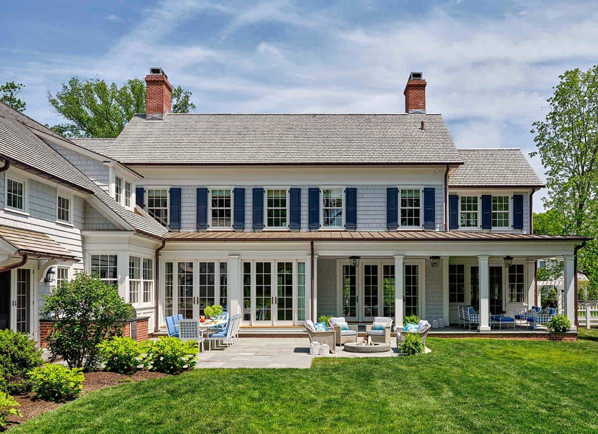 Rear exterior of colonial revival home with covered porch and patio