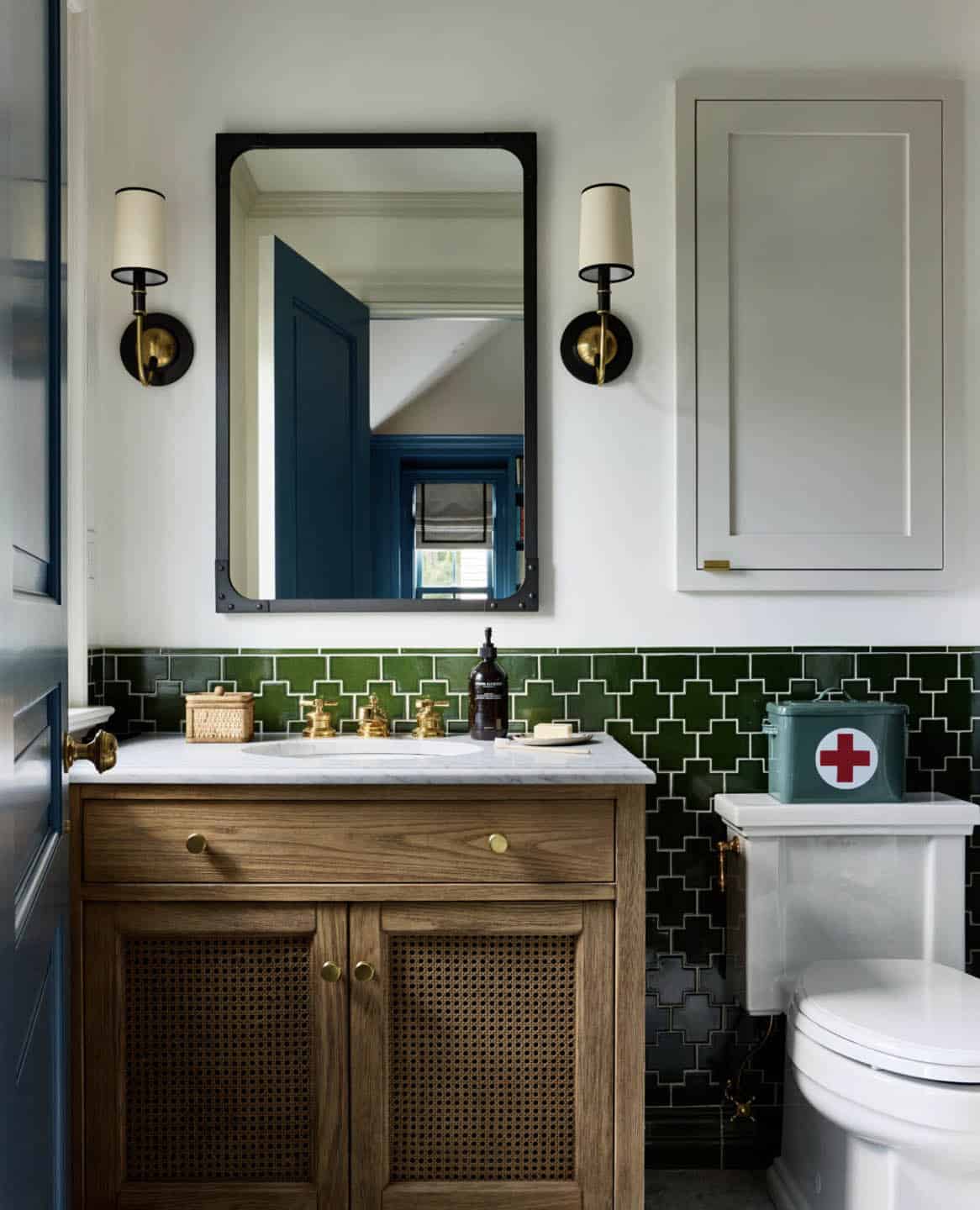 Bathroom with green patterned tile and wood cane vanity