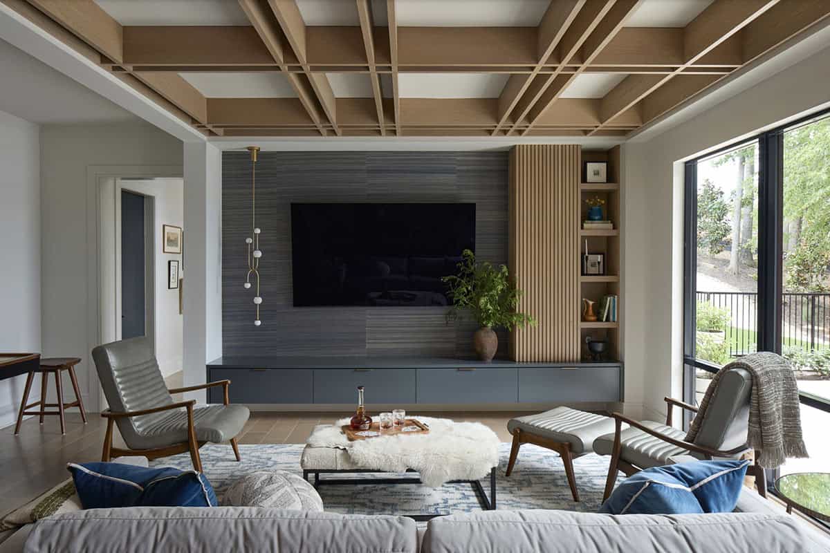 Living room with geometric wood lattice ceiling, TV wall, and mid-century style seating