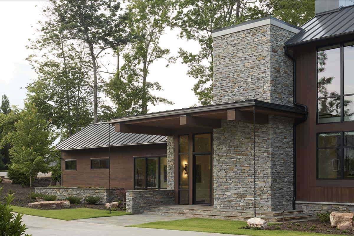 Stone entry tower with cantilevered wood-clad roof overhang and glass front door