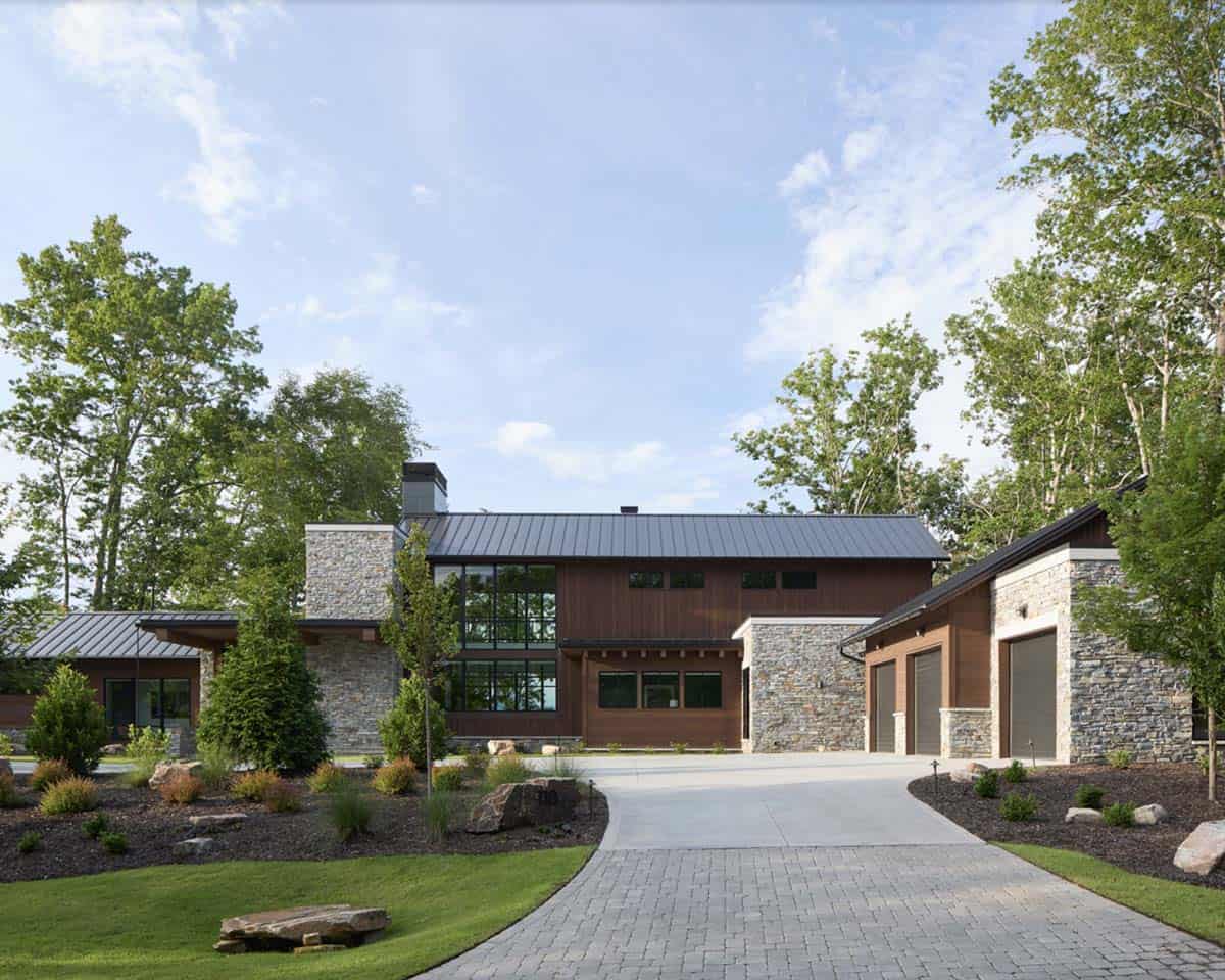 Front view of the house and three-car garage with stone accents and circular driveway