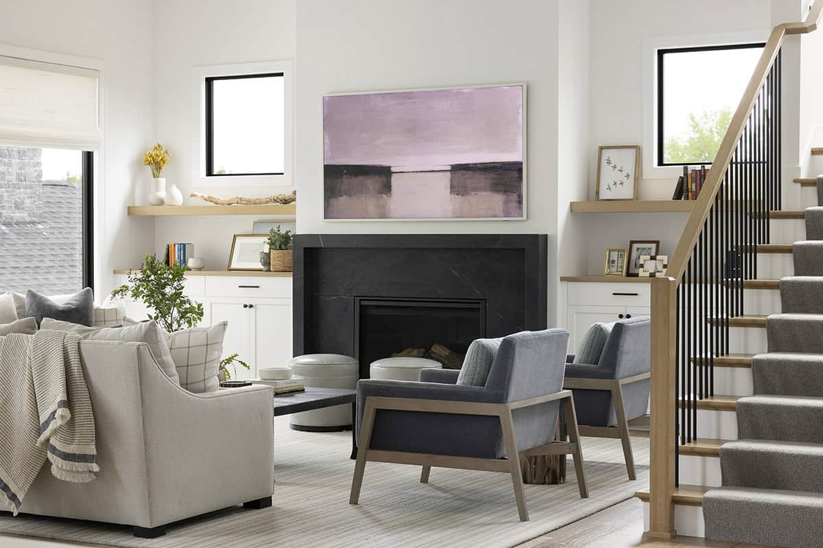 Living room with black marble fireplace and framed art above mantel