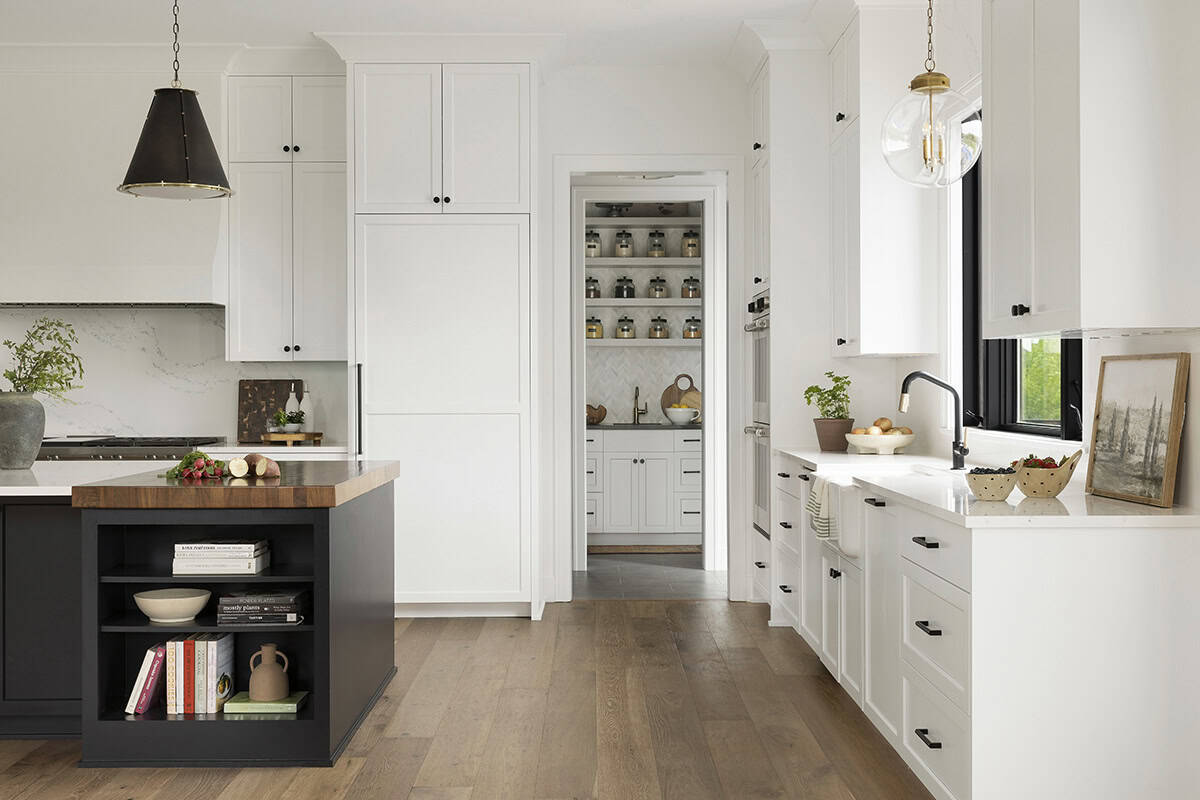White kitchen island with view into tiled butler's pantry