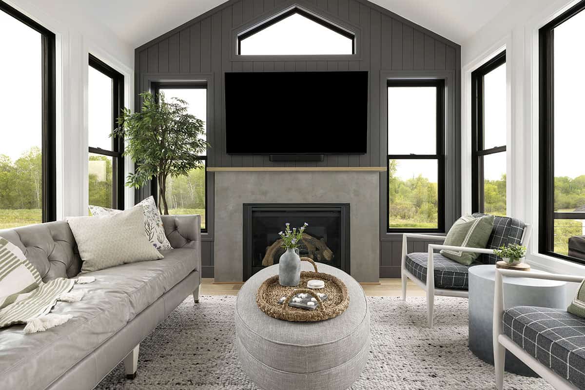 Sunroom with black shiplap accent wall and wall-mounted TV above fireplace