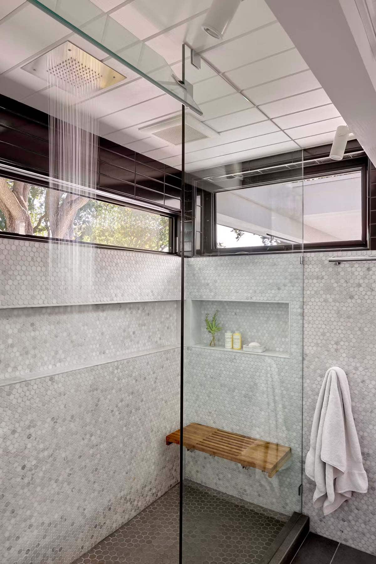 Walk in shower with penny tile and rainfall showerhead