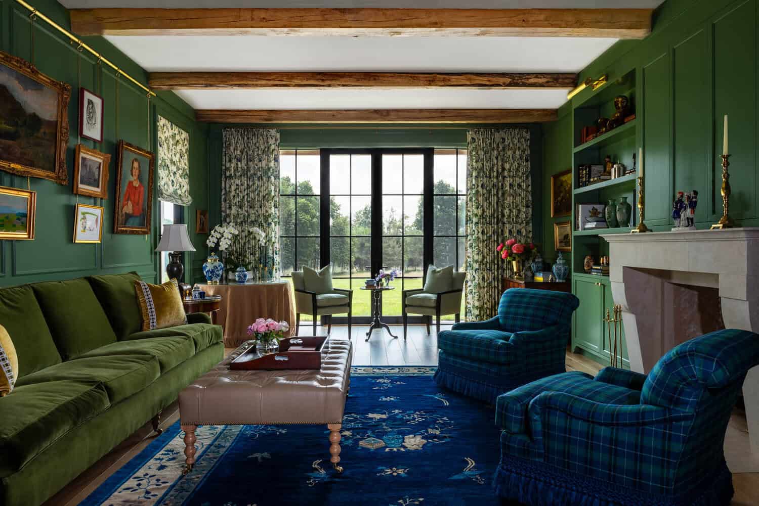 Green library with stone fireplace and blue Chinese rug